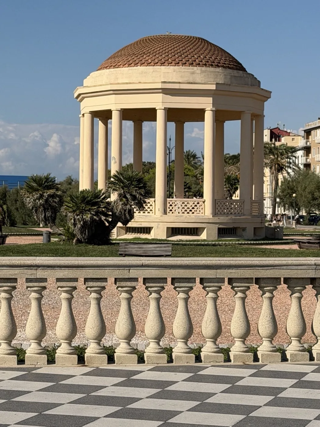 The gazebo of Terrazza Mascagni behind the stone balustrade, with the black and white chequered floor in the foreground.