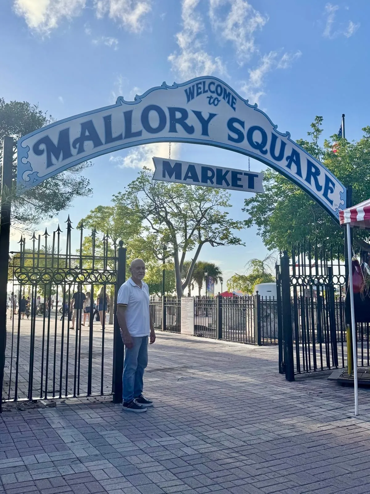 Anna’s companion under the entrance arch with the words “Welcome to Mallory Square”.