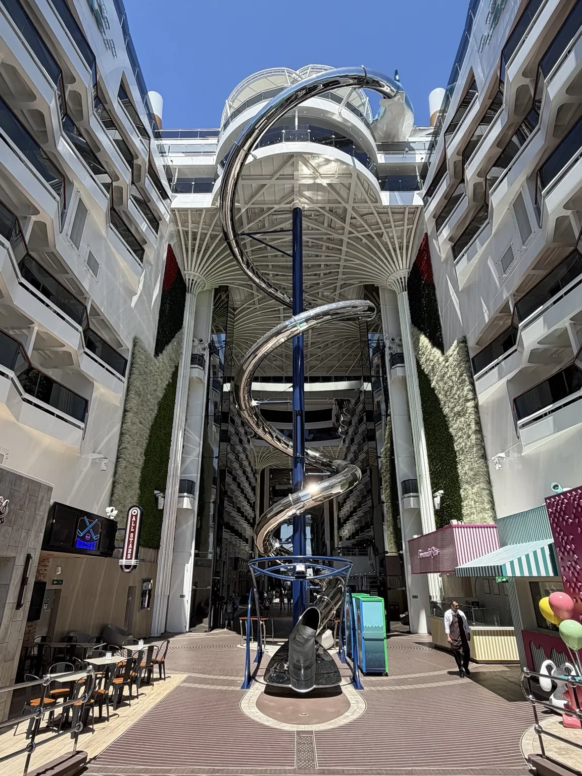 The big metal spiral slide dropping between the ship’s two rows of balconies.