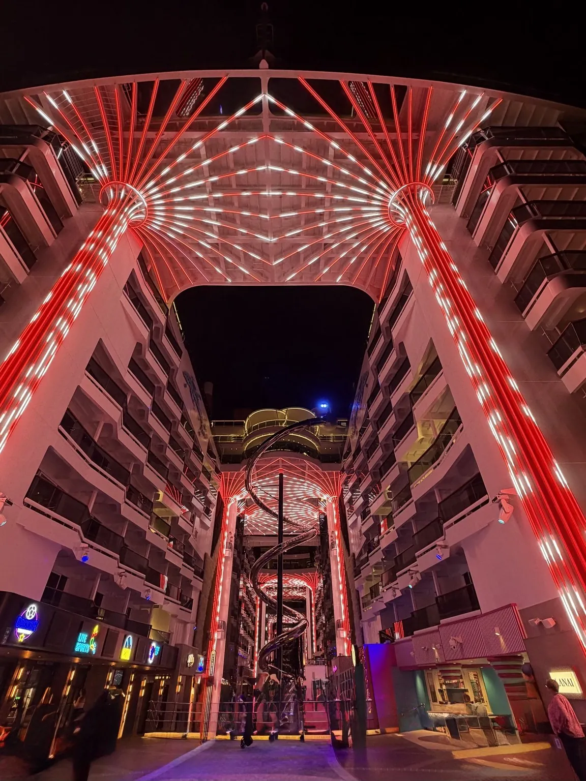 The big palm-shaped structures lit up in red above the promenade, between the ship’s rows of balconies.